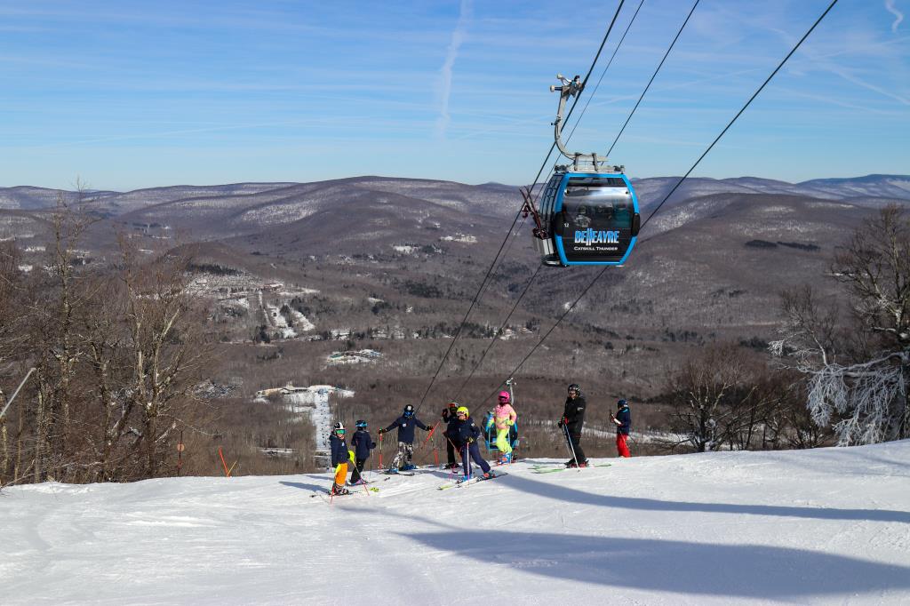 ski life white patches and hills with trees, no leaves. 