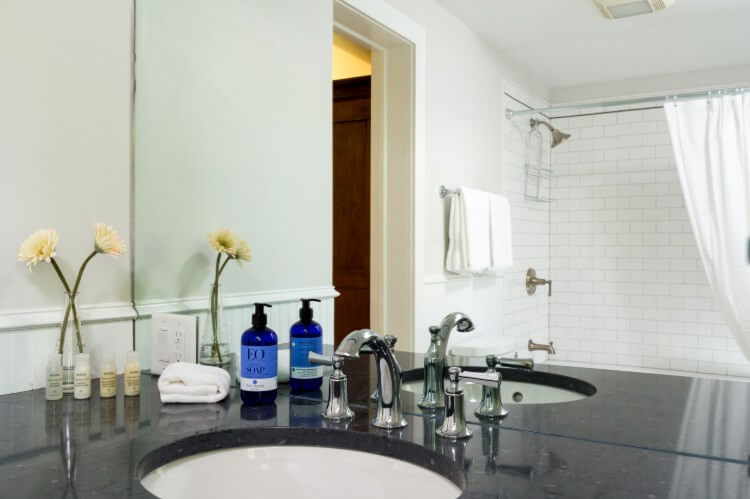 Black counter top with bath amenities.