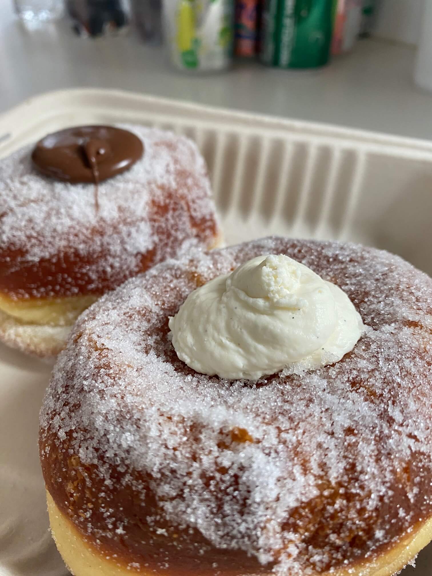 a doughy, fluffy pastry with sugary top stuffed with cream 